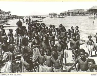 NEW GUINEA. 1942. NATIVE CHILDREN ON THE BEACH AT ONE OF THE VILLAGES VISITED BY PPI. MAJOR GENERAL B.M. MORRIS, DSO, COMMANDING OFFICER, NEW GUINEA LINES OF COMMUNICATION AREA AND THE AUSTRALIAN ..
