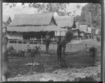 Children in garden, beside village dwellings