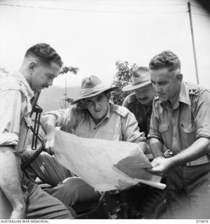 WAU - BULLDOG ROAD, NEW GUINEA, 1944-02024. NX70161 MAJOR F. MUNRO (2), COMMANDING OFFICER OF THE 2/34TH GENERAL TRANSPORT COMPANY PICTURED WITH SOME OF HIS OFFICERS. IDENTIFIED PERSONNEL ARE: ..