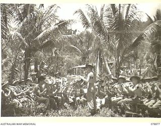 JACQUINOT BAY, NEW BRITAIN. 1945-01-29. THE BAND OF THE 28TH INFANTRY BATTALION PRACTICING IN A SECLUDED SECTION OF THE JUNGLE SOME DISTANCE FROM THEIR CAMP. IDENTIFIED PERSONNEL ARE:- VX120104 ..