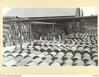 PORT MORESBY, NEW GUINEA. 1944-06-27. THE 44 GALLON DRUM FILLING PLATFORM OF THE 1ST BULK PETROLEUM STORAGE COMPANY