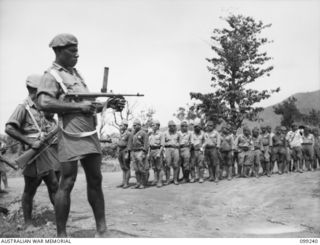 RABAUL, NEW BRITAIN, 1945-12-05. SUSPECTED JAPANESE WAR CRIMINALS WERE ROUNDED UP AND DETAINED IN A COMPOUND IN HQ 11 DIVISION AREA AND GUARDED BY TROOPS OF NEW GUINEA INFANTRY BATTALION. SHOWN, A ..