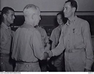 MARIANA ISLANDS. C.1945. VICE ADMIRAL G. D. MURRAY USN, COMMANDER MARIANAS, CONGRATULATES LIEUTENANT HENRY J. FONDA USNR AFTER PRESENTING HIM WITH BRONZE STAR MEDAL IN THE NAME OF THE PRESIDENT OF ..