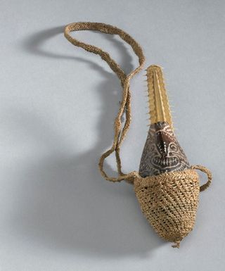 ["Coconut charm to ward off evil spirits, Papua New Guinea, 18"]