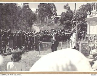 HERBERTON, QLD. 1944-04-25. NX202776 CHAPLAIN G. STUART WATTS, CHURCH OF ENGLAND, 2/1ST PIONEER BATTALION (1) ADDRESSING THE ASSEMBLY AT THE WAR MEMORIAL DURING THE ANZAC DAY SERVICE. IN THE CENTRE ..