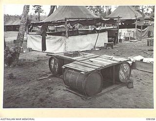 WEWAK, NEW GUINEA. 1945-10-28. A FLOATING DOCK BUILT BY MEMBERS OF 16 INFANTRY BRIGADE. IT IS BUILT OF PETROL DRUMS AND EQUIPPED WITH A FISH TRAP. IT WILL BE USED FOR RUNNING REPAIRS ON CRAFT ..