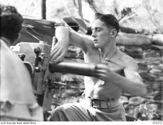 NAGADA, NEW GUINEA. 1944-08-16. VX70936 GUNNER J. LESLIE, LOADER (1) AND VX10576 GUNNER H.C. REID, GUNLAYER (2) LOADING AND LAYING A 6 POUNDER TANK ATTACK GUN DURING A PRACTICE SHOOT BY E TROOP, ..