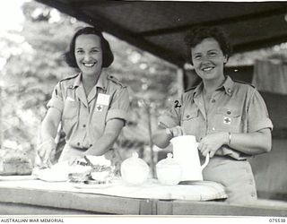 MADANG, NEW GUINEA. 1944-08-25. B4/8 GRACE MOORE (1) AND B2/383 MURIEL LAKEMAN (2) AUSTRALIAN RED CROSS SOCIETY, PREPARING MORNING TEA FOR THE PATIENTS OF THE 2/11TH GENERAL HOSPITAL