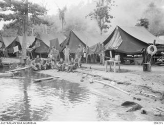 RABAUL, NEW BRITAIN, 1945-11-26. PERSONNEL OF 11 DIVISION, SALVAGE UNIT OUTSIDE THE MENL'S TENT LINES IN THEIR CAMP AREA ON THE SHORES OF SIMPSON HARBOUR