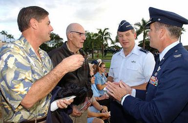 Mr. James Tapp Jr. (left) and his dad, retired US Army Air Force (USAAF) Colonel (COL) James Tapp, speak with US Air Force (USAF) General (GEN) William J. Begert, Commander, Pacific Air Force (PACAF), and USAF COL Raymond G. Torres (right), Commander, 15th Airlift Wing (AW), before the December 7th Pearl Harbor Memorial Ceremony at Hickam Air Force Base (AFB), Hawaii