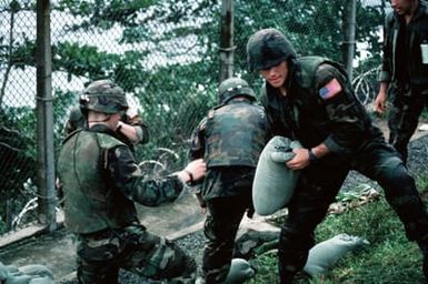 Marines on the grounds of the US Embassy sandbag a position near the compound's perimeter. Marines of the 22nd Marine Expeditionary Unit (22nd MEU), deployed aboard the amphibious assault ship USS SAIPAN (LHA 2), were sent to augment security at the embassy as part of Operation SHARP EDGE