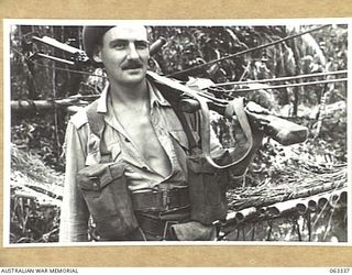 FAITA, RAMU VALLEY, NEW GUINEA. 1944-01-07. VX55541 CORPORAL G. B. KENNEDY OF EAST BRUNSWICK, VIC, ORDERLY ROOM CORPORAL AND ORIGINAL MEMBER OF THE UNIT, 2/2ND COMMANDO SQUADRON