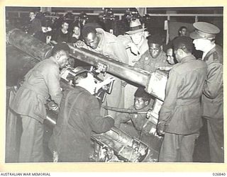 MARIBYRNONG, AUSTRALIA. 1942-10-12. SIX NATIVE SOLDIERS FROM NEW GUINEA ARE HAVING EXPLAINED TO THEM THE TECHNICALITIES OF MACHINERY AT THE MUNITION WORKS AT MARIBYRNONG WHERE THEY WERE SHOWN OVER ..