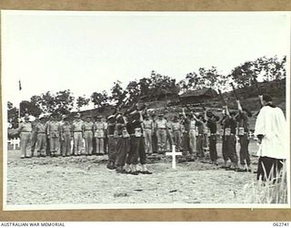 BOMANA WAR CEMETERY, PAPUA, NEW GUINEA. 1943-12-29. AT THE CONCLUSION OF A MEMORIAL SERVICE CONDUCTED BY CHAPLAIN J. D. MCKIE, CHURCH OF ENGLAND, A FIRING PARTY IN CHARGE OF QX226 SERGEANT N. L. ..