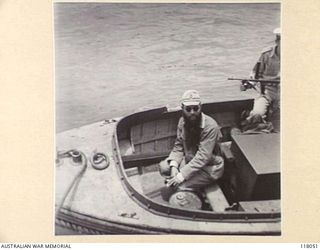 MENADO, CELEBES. 1945-09-15. WO YAMADA, IMPERIAL JAPANESE ARMY, CONTROLLER OF THE AIRMEDIDE WOMEN'S CAMP (A SUSPECTED WAR CRIMINAL) ABOARD A MOTOR BOAT ON HIS WAY TO THE RAN VESSEL, HMAS GLENELG ..