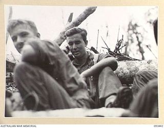 WEWAK AREA, NEW GUINEA. 1945-06-27. CAPTAIN M.J. DWYER, OFFICER COMMANDING C COMPANY, 2/8 INFANTRY BATTALION (2), SPEAKING ON THE PHONE DURING THE ACTION AGAINST JAPANESE FORCES ON MOUNT ..