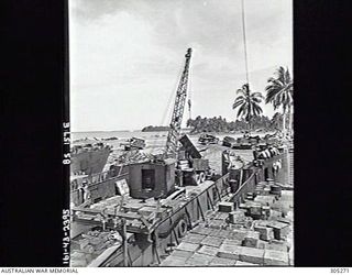 SEGI, NEW GEORGIA, BRITISH SOLOMON ISLANDS PROTECTORATE. C.1944. A CRANE IS USED TO UNLOAD STORES FROM A LANDING CRAFT TANK. (NAVAL HISTORICAL COLLECTION)