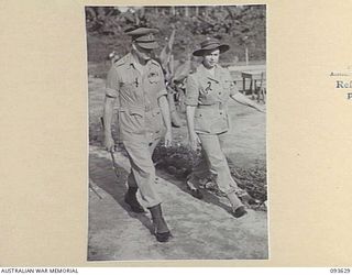 TOROKINA, BOUGAINVILLE, 1945-07-04. HIS ROYAL HIGHNESS, THE DUKE OF GLOUCESTER, GOVERNOR-GENERAL OF AUSTRALIA (1), AND MATRON M.E. HURLEY (2), GOING TO AFTERNOON TEA AFTER INSPECTING 2/1 GENERAL ..