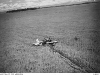 NEW GUINEA. 1944-02-27. FOLLOWING AN AIR RAID BY VULTEE VENGEANCE DIVE BOMBER AIRCRAFT OF NO. 24 SQUADRON RAAF ON THE JAPANESE-HELD AIRSTRIP AT ALEXISHAFEN ON THE NORTH COAST OF NEW GUINEA. FLYING ..