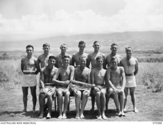 KELANOA, NEW GUINEA, 1944-02-21. MEMBERS OF THE 2/14TH FIELD REGIMENT, 8TH DIVISION, (THE COLOUR PATCH IS BROKEN IN HALF TO DENOTE THE BROKEN 8TH), ARE THE WINNING TEAM OF COMBINED BEACH SPORTS ..