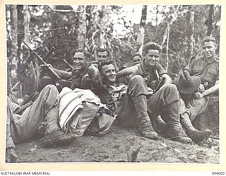 WEWAK AREA, NEW GUINEA, 1945-07-13. PERSONNEL OF B COMPANY, 2/8 INFANTRY BATTALION, RESTING ON A TRACK. THEY ARE ON THEIR WAY TO A NEW BIVOUAC AREA TO BE IN READINESS TO SUPPORT A COMPANY IN THEIR ..