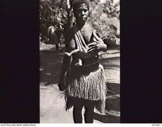 KAIAPIT, NEW GUINEA. 1943-09-24. NATIVE WOMAN AND HER PICCANINNY (BABY), IN THE LOCAL VILLAGE