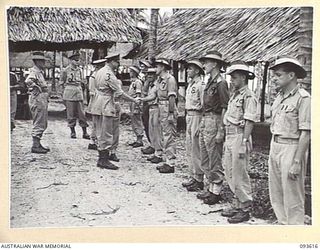 JACQUINOT BAY, NEW BRITAIN, 1945-07-02. HIS ROYAL HIGHNESS, THE DUKE OF GLOUCESTER, GOVERNOR-GENERAL OF AUSTRALIA (3), SHAKING HANDS WITH MAJOR A.G.N. NILSON (7), WHILE BEING INTRODUCED TO OFFICERS ..
