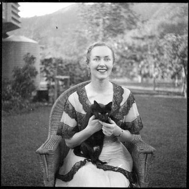 Portrait of Ruth McNicholl seated outside holding a kitten, Malaguna Road, Rabaul, New Guinea, ca. 1936 / Sarah Chinnery