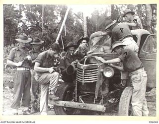 WIRUI BEACH, WEWAK AREA, NEW GUINEA. 1945-08-25. TROOPS OF 2/11 INFANTRY BATTALION PUTTING A CAPTURED JAPANESE TRUCK INTO SERVICEABLE CONDITION. IDENTIFIED PERSONNEL ARE:- PRIVATE L.A. HEAD (3); ..