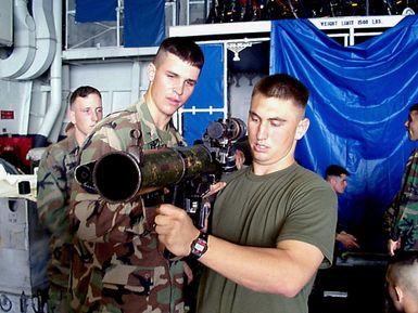 U.S. Marine Lance Corporals Eric Brady and Chad Mullin train with an 83 mm Shoulder-launched Multipurpose Assault Weapon (SMAW) aboard the amphibious assault ship USS GUAM (LPH 9). The GUAM is in transit to the Persian Gulf in response to a US Central Command (US CENTCOM) request for an increased military presence in the region. Operation SOUTHERN WATCH, 13 February 1998