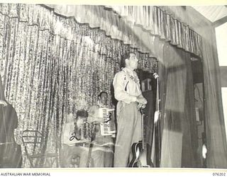 LAE, NEW GUINEA. 1944-09-26. MEMBERS OF THE "TANKS A MILLION" CONCERT PARTY STAGING AN ACT IN THE NEW RECREATION HALL BUILT BY MEMBERS OF THE 22ND WORKS COMPANY, ROYAL AUSTRALIAN ENGINEERS AND ..