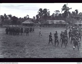 LAE, NEW GUINEA, 1946-02-14. AT A SPECIAL PARADE, MAJOR GENERAL B.M. MORRIS, GENERAL OFFICER COMMANDING AUSTRALIAN NEW GUINEA ADMINISTRATIVE UNIT, PRESENTED GIFTS (FRAMED COLOURED PHOTOGRAPHS OF ..