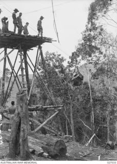 PAPUA, NEW GUINEA. 1942-10. "FLYING FOX", CONSTRUCTED BY 2/6TH FIELD COMPANY ROYAL AUSTRALIAN ENGINEERS, TO CARRY SUPPLIES DOWN THE STEEP GRADE FROM END OF ROAD TO DEEP VALLEY BELOW, ON START OF ..