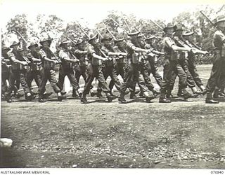 LAE, NEW GUINEA, 1944-03-08. MEMBERS OF BRIGADE HEADQUARTERS, 29TH INFANTRY BRIGADE MARCH PAST VC20308 MAJOR-GENERAL F.H. BERRYMAN, CBE, DSO, GENERAL OFFICER COMMANDING 2ND AUSTRALIAN CORPS AT A ..