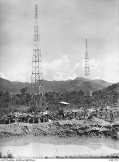 SALAMAUA, NEW GUINEA, 1943-09-26. THE WIRELESS STATION WHICH SUFFERED HEAVY BOMB DAMAGE, DURING THE ALLIED AIR RAIDS. MT TAMBU IN THE BACKGROUND IS THE HIGHEST PEAK