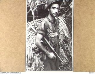 GUY'S POST, FARIA RIVER AREA, NEW GUINEA. 1943-11-08. NX13159 CORPORAL L. W. SKIFFINGTON OF PARRAMATTA, NSW, AND OF THE 2/33RD AUSTRALIAN INFANTRY BATTALION MOVING TO GUY'S POST TO RELIEVE MEMBERS ..