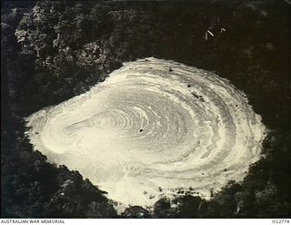 NEW GUINEA. C. 1944. AERIAL PHOTOGRAPH OF AN INLAND LAKE SURROUNDED BY JUNGLE