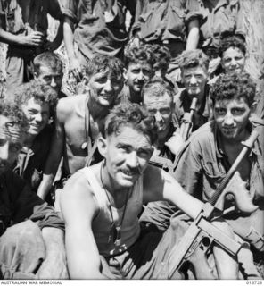 These Australians have just come 100 yards back from the front for food during a lull in the fighting. They are part of a company, most likely of the 2/33rd Battalion, which has been 2 days and ..