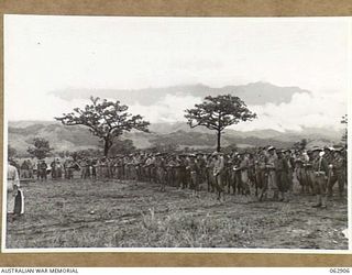 DUMPU, NEW GUINEA. 1944-01-16. THE 58/59TH INFANTRY BATTALION CEREMONIAL CHURCH PARADE IN PROGRESS AT THE UNIT HEADQUARTERS. ATTENDING THE PARADE WERE VX9 MAJOR GENERAL G. A. VASEY, CB., CBE., ..