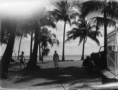 [Man and woman looking out to sea in Pacific Island location]