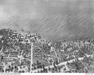 Madang, New Guinea, 1945-10. Aerial view of Madang Harbour, showing several ships at anchor and, at left, two Consolidated Catalina flying boats floating on the water