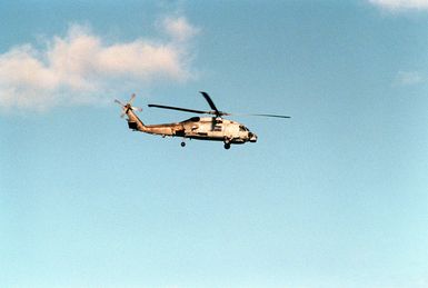 A light helicopter Anti-submarine Squadron 49 (HSL-49) SH-60B Sea Hawk helicopter flies over the Hawaiian coast.