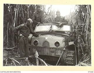 Australian officers of the 35th Infantry Battalion, examining a Japanese Type 98 Isuzu, 6 ton artillery tractor, which was captured at the Rempi River north of Alexishafen. Fitted with a six ..