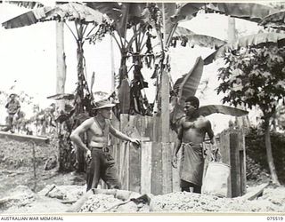 MADANG, NEW GUINEA. 1944-08-25. QX50570 SAPPER F. NEUMANN, ROYAL AUSTRALIAN ENGINEERS, SUPERVISING THE SINKING OF A WELL TO SUPPLY WATER TO THE 2/11TH GENERAL HOSPITAL