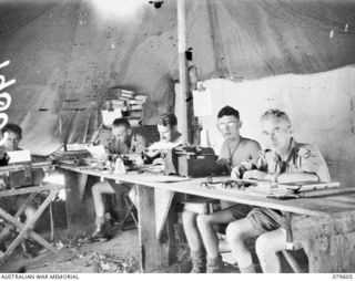 ORO BAY, NEW GUINEA. 1943-04. PERSONNEL WORKING IN THE FIRST REGIMENTAL OFFICE OF 10TH FIELD AMBULANCE. PRIVATE (PTE) W. R. SINCOCK; CORPORAL L. WILLIAMS; PTE C. G. CAPSTICK AND SERGEANT A. W. ..