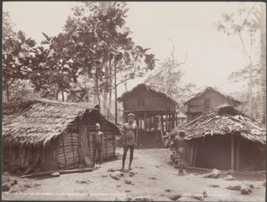 A man and two children in the village of Foate, Malaita, Solomon Islands, 1906 / J.W. Beattie