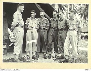 MILILAT, NEW GUINEA. 1944-08-07. THE STAFF OF THE CHIEF ELECTRICAL AND MECHANICAL ENGINEER OUTSIDE THEIR TENT OFFICE AT HEADQUARTERS, 5TH DIVISION. IDENTIFIED PERSONNEL ARE:- VX63284 CAPTAIN J.K. ..