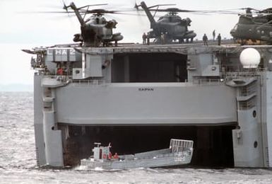 An LCM 6 mechanized landing craft prepares to enter the docking well of the amphibious assault ship USS SAIPAN (LHA 2) during NATO Exercise NORTHERN WEDDING '86