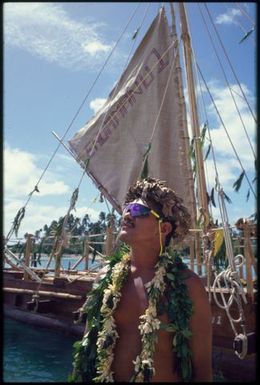 Man wearing leaf wreaths and sunglasses