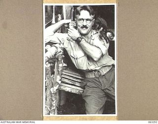 FAITA, NEW GUINEA. 1944-01-07. NX58995 WARRANT OFFICER CLASS 2, J. S. O'BRIEN OF BONDI, NSW, AND OF THE 2/2ND COMMANDO SQUADRON WITH TWO OF THE FIVE KITTEN MASCOTS OF THE UNIT. THE KITTENS WERE ..